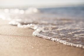 sea foam wave on sand