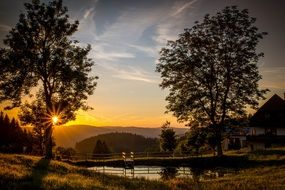 landscape of romantic sunset on the pond