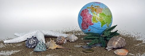 globe, coins and sea shells