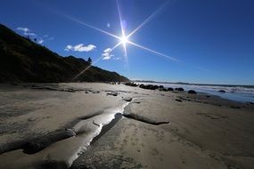 bright sun over New Zealand beach