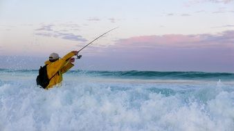 fisherman in the ocean foam wave