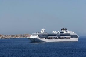 remote view of a cruise ship on the water on a sunny day