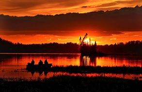 fishermen on the lake at dusk