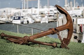 old rusty Shipping Anchor on hillside in Port