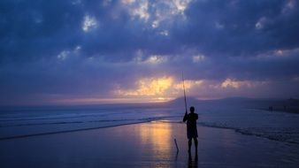 fisherman at sea at dusk