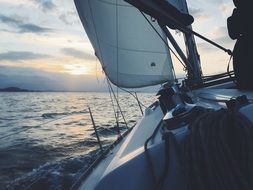 Sailing Boat in ocean at the sunrise
