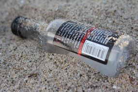 bottle in gray sand