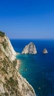 cliff in the blue sea in greece