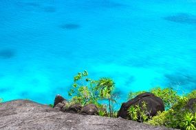 view from large stones to turquoise water
