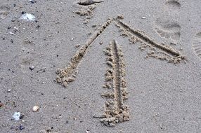 footprints and arrow in the sand
