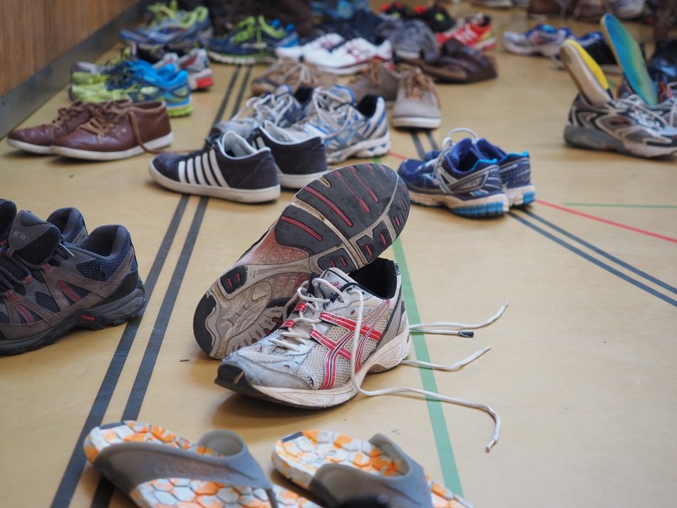 a bunch of sneakers at the gym entrance