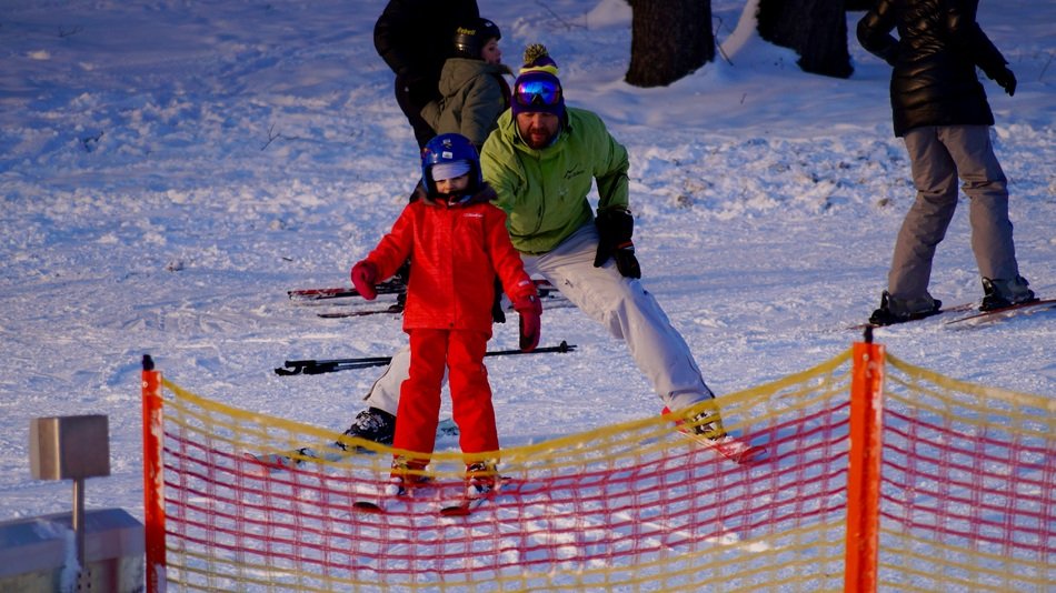skiers in the snow near the net