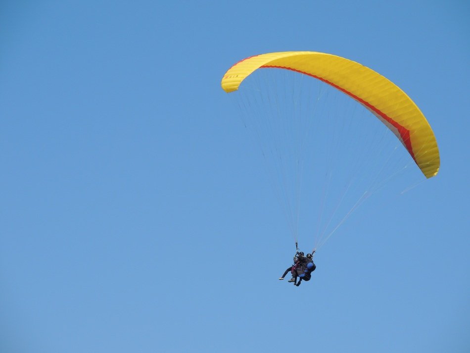 paragliding tandem in the blue sky