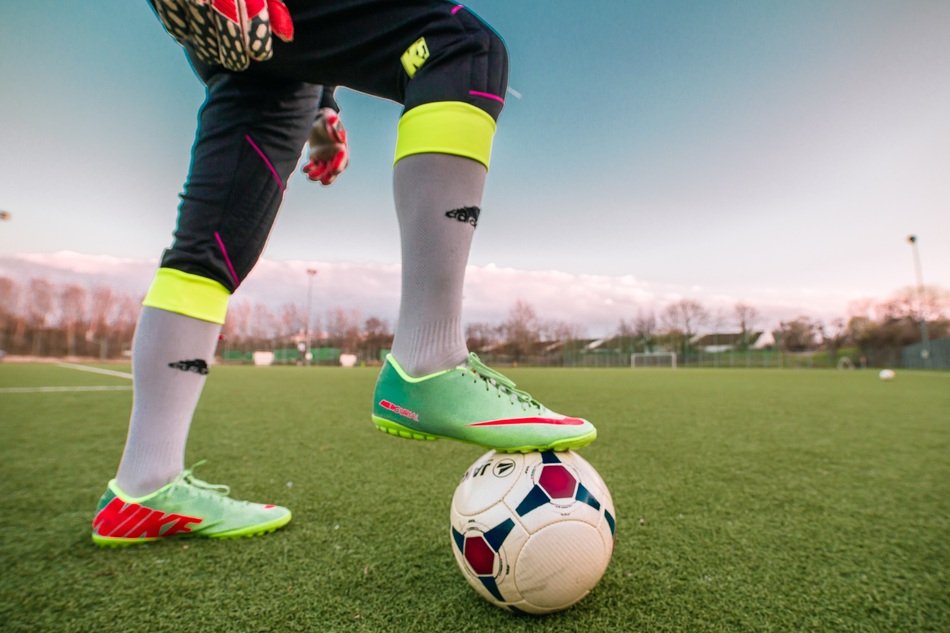 football goalkeeper with a ball on the field