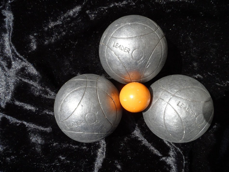 PÃ©tanque, small orange and big silver Balls on the dark background