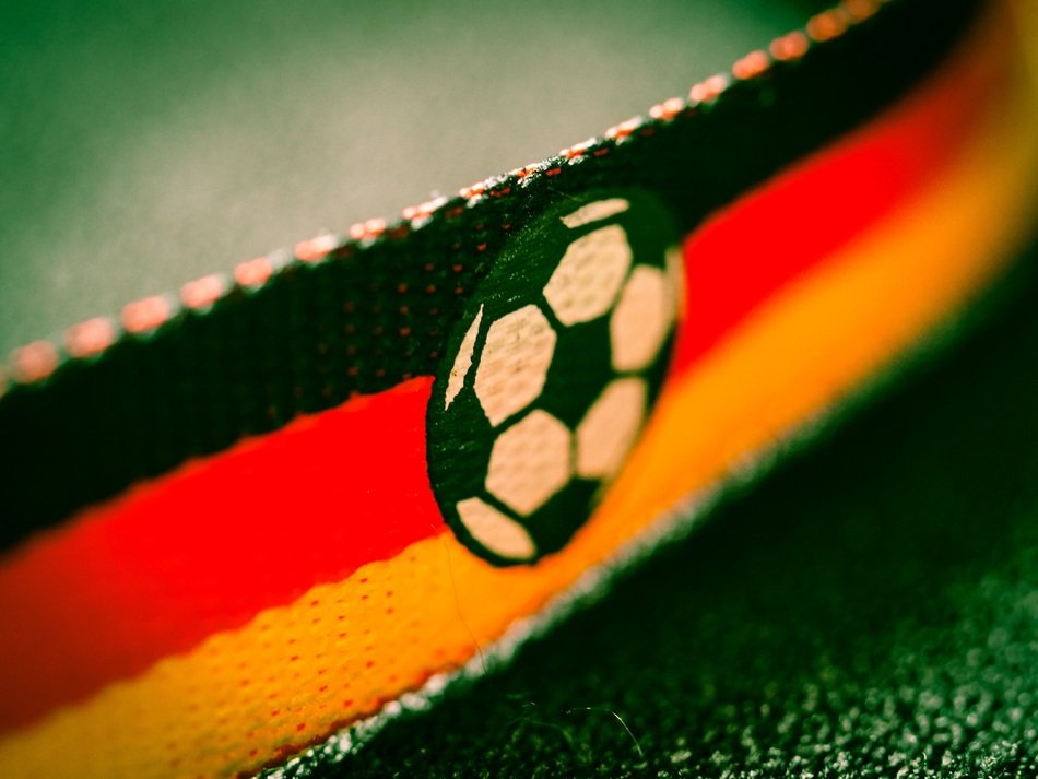 closeup picture of ball on the flag of germany at the bright football championship