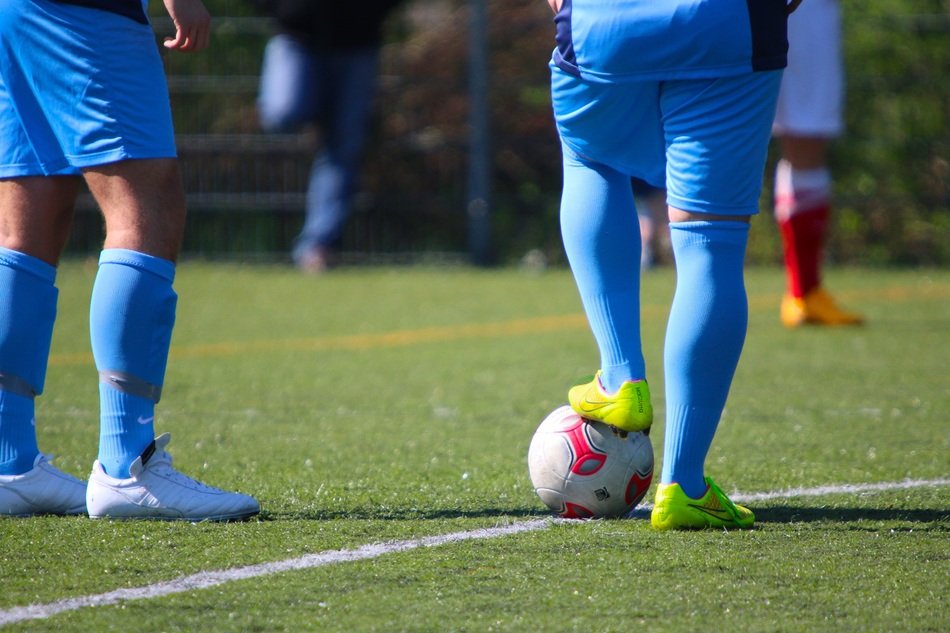 Colorful football players on the meadow