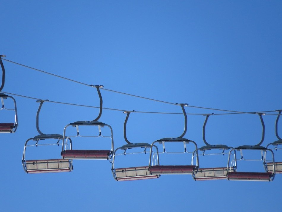 chairlifts on the blue sky