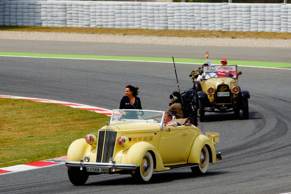 Kimi Matias Raikkonen on a retro race car on the track