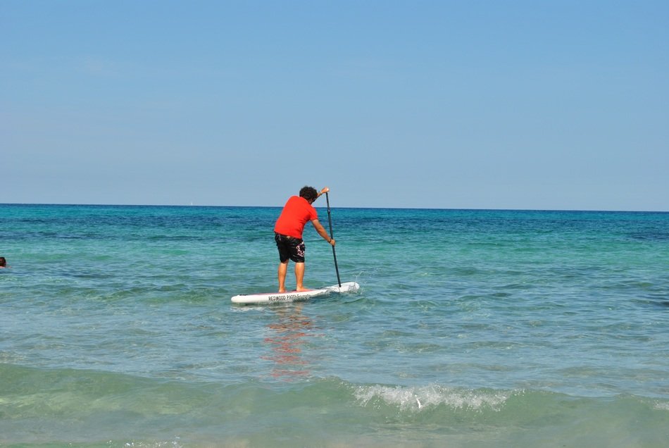 man on Surf board on calm Water, spain, mallorca