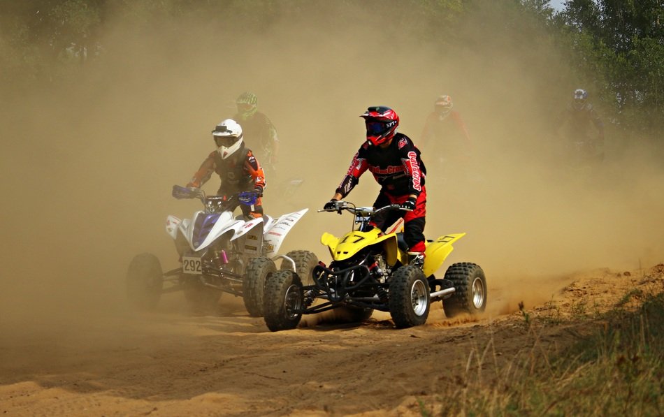 races on motocross in the dust on a sunny day