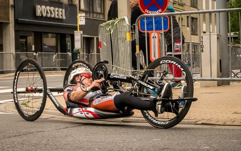 athlete on a handbike rides down the street