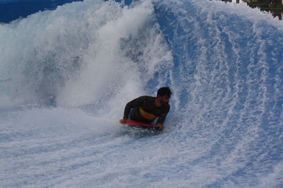 man windsurfing on a wave