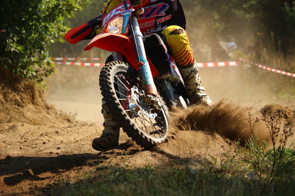 motorcycle racing among the sand in the sun