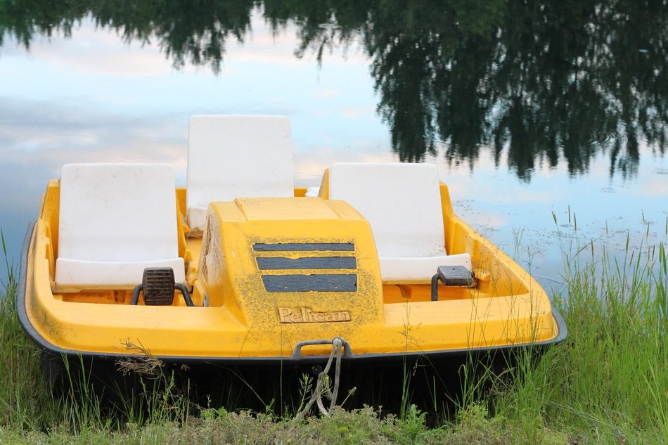 Kayak stands on the shore near the river