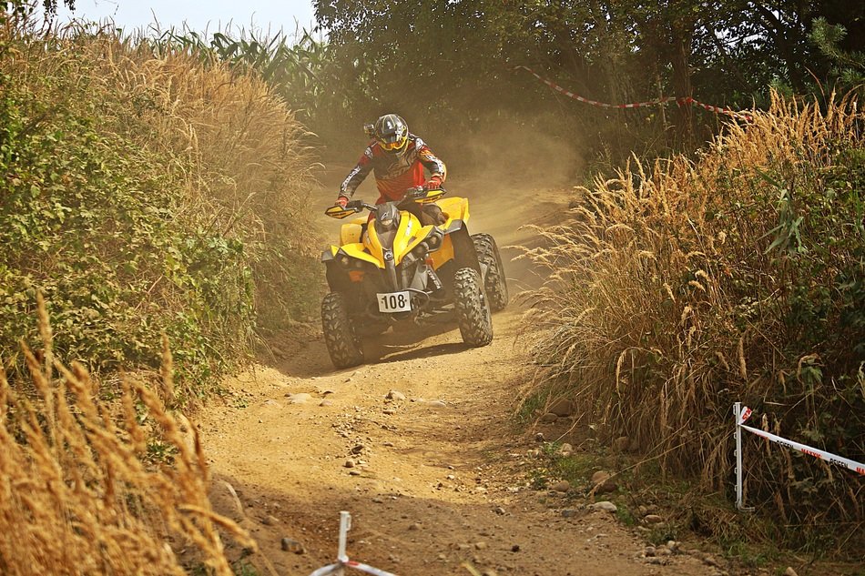 rider on quad speeding on track