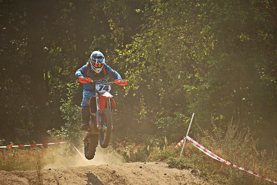 Motorcycle sport in the dust on a sunny day