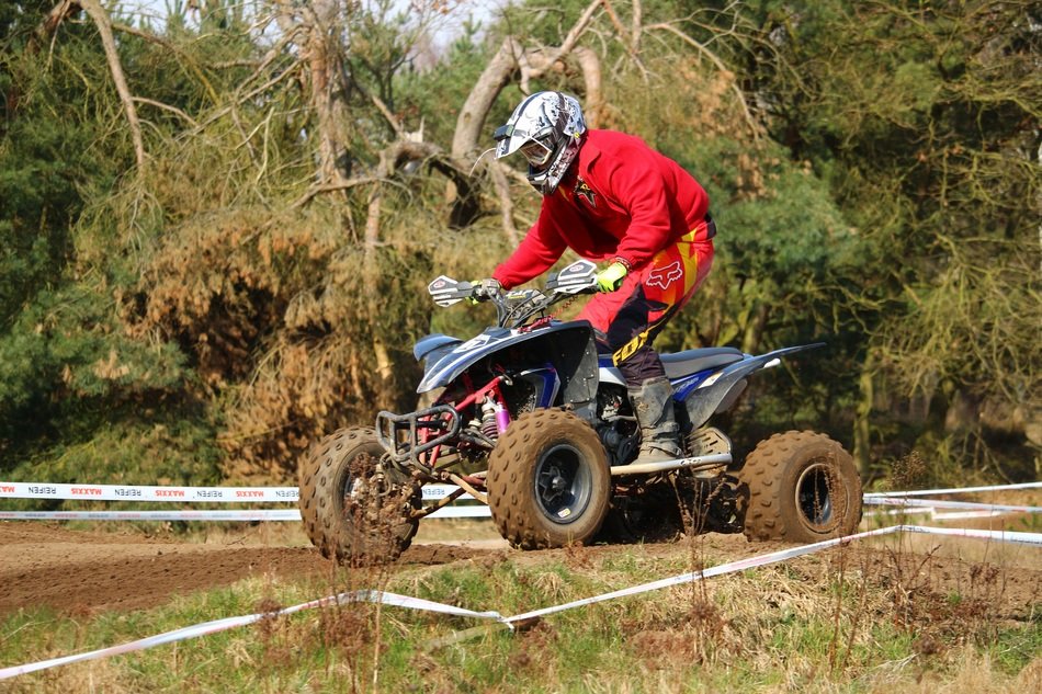 motorcycle racer in red on a quad bike