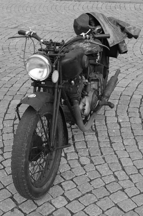 Black Oldtimer Moped parked on pavement