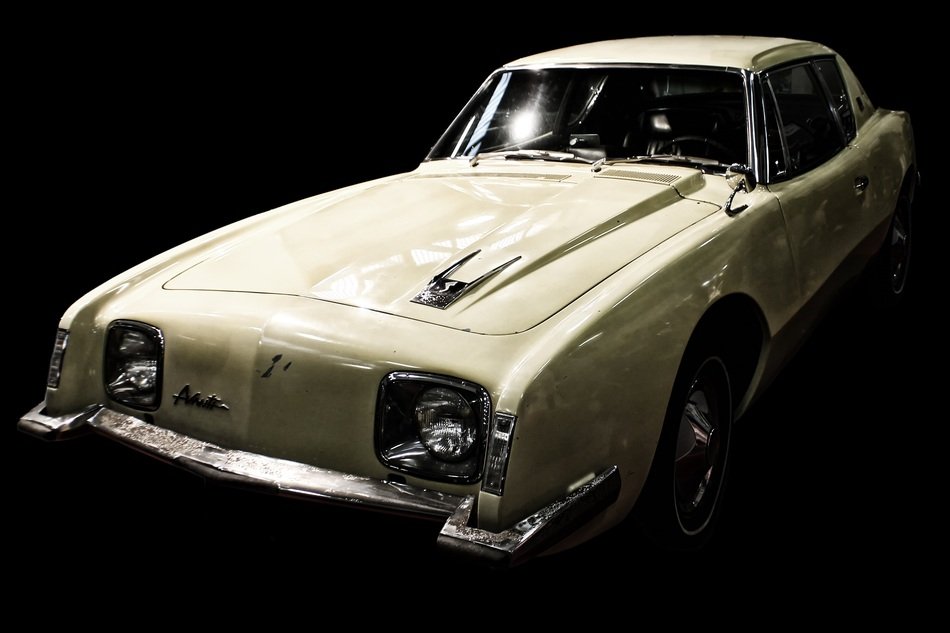 white vintage car on the black background