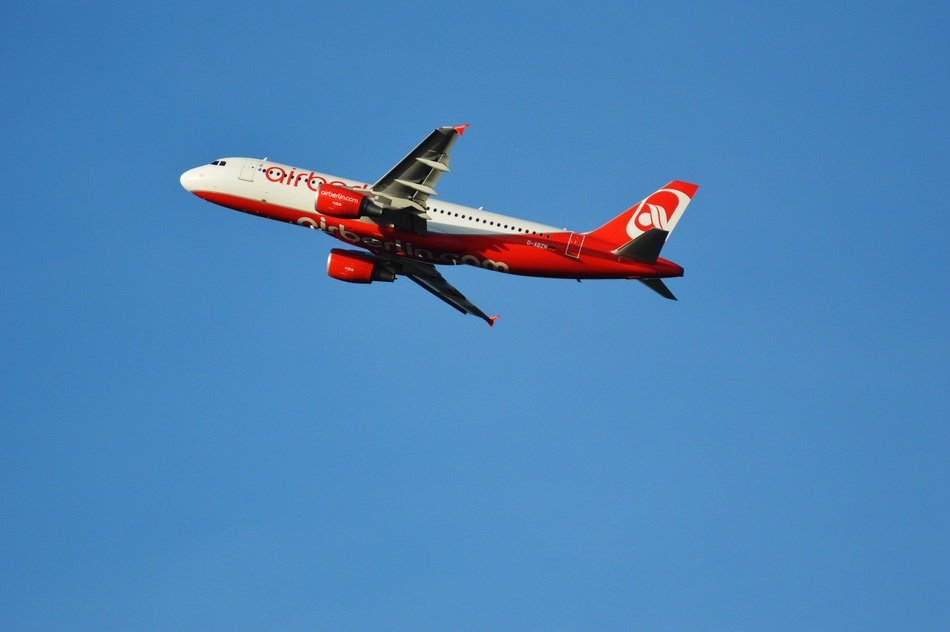 red and grey passenger Aircraft in flight