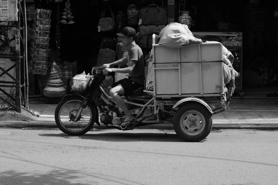 Black and white photo of the man with the moped in Vietnam