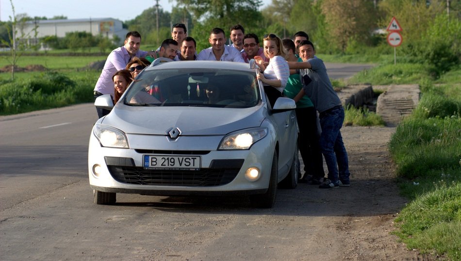 funny group of people around a Renault car