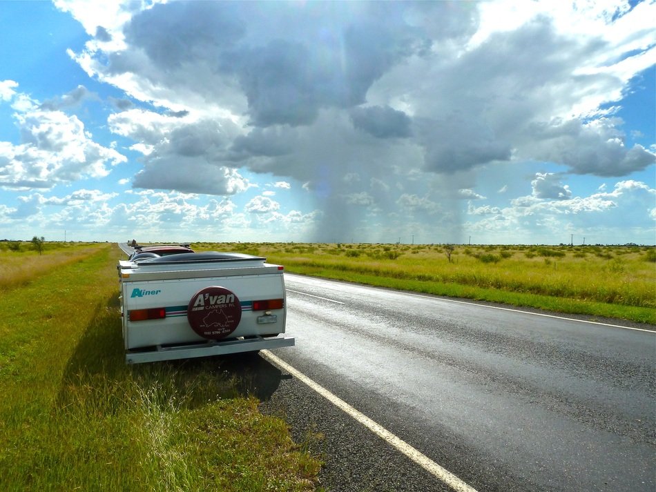 car on the roadside among green fields
