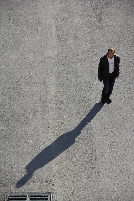photo of a man in Istanbul and his shadow on the pavement