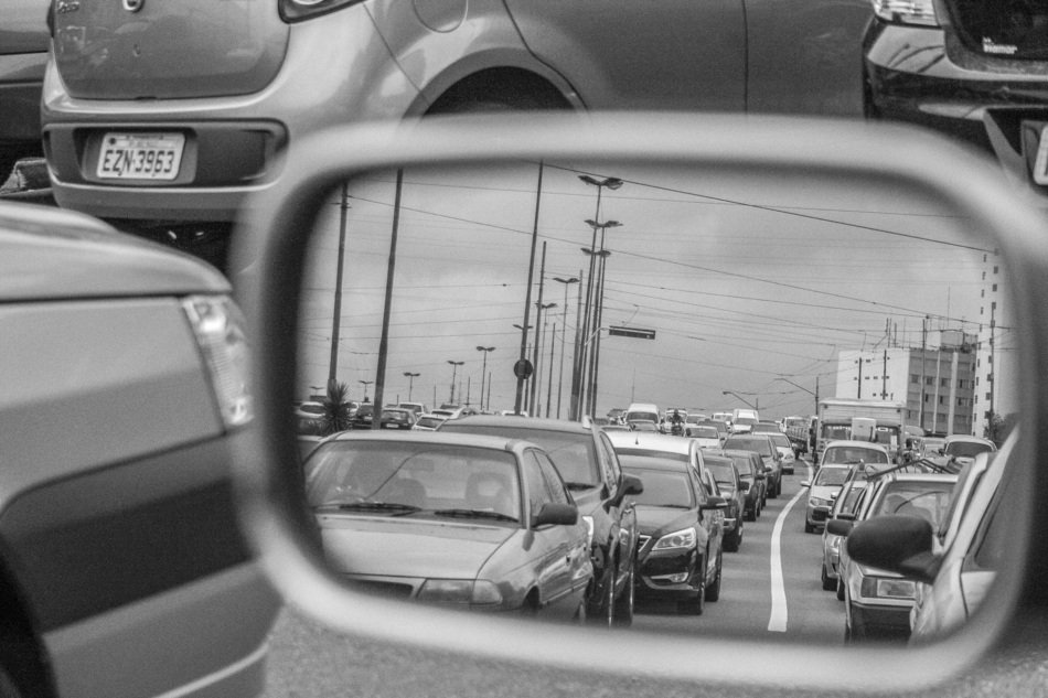 black and white photo of a side mirror of a car