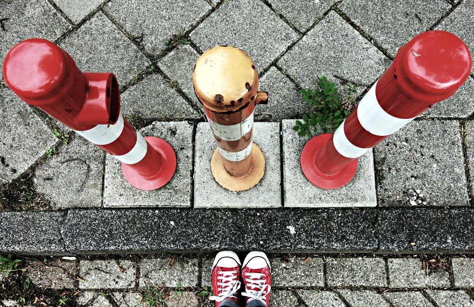 striped protective barriers at the curb