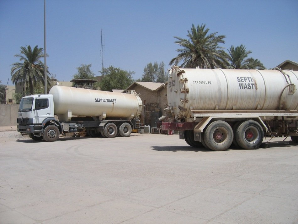 trucks among palm trees in iraq
