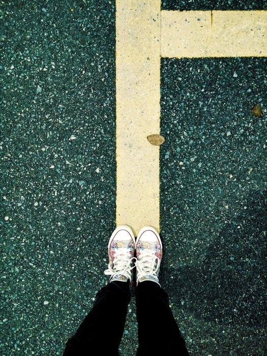feet on the yellow line on the road