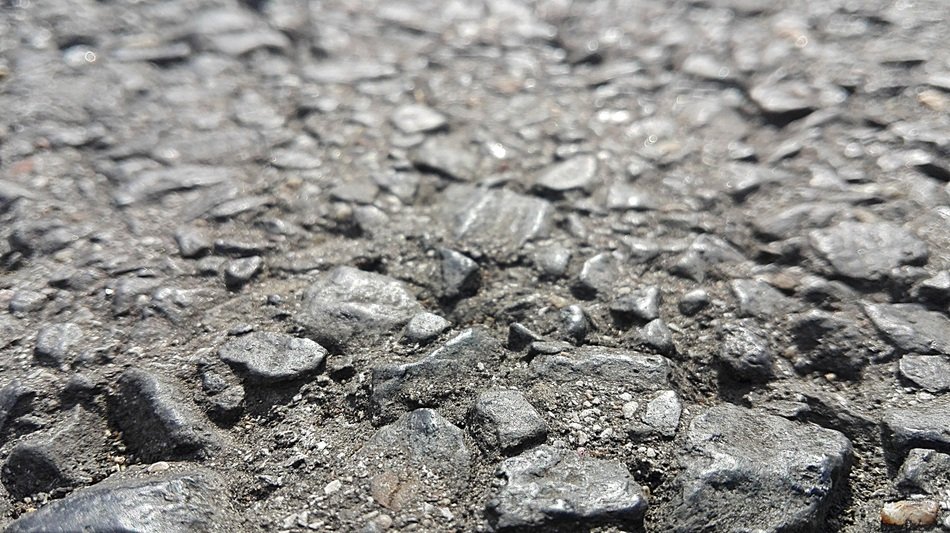 Gravel in the road made of asphalt