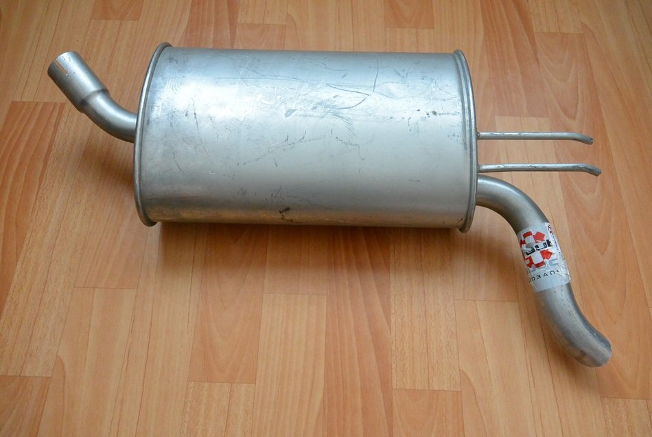 silencer as an exhaust system on the wooden floor
