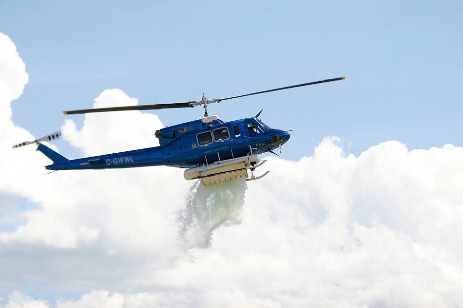 blue rescue helicopter dumps water