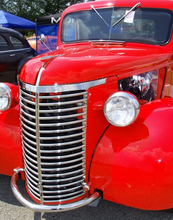 red vintage car in the sun close up