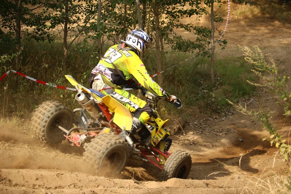 rider in yellow uniform on a quad bike