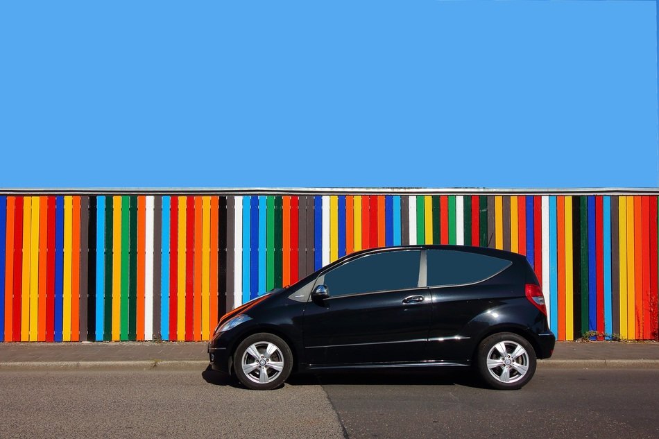 black small Mercedes near a colorful wall