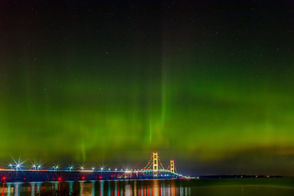 aurora borealis over a bridge in michigan